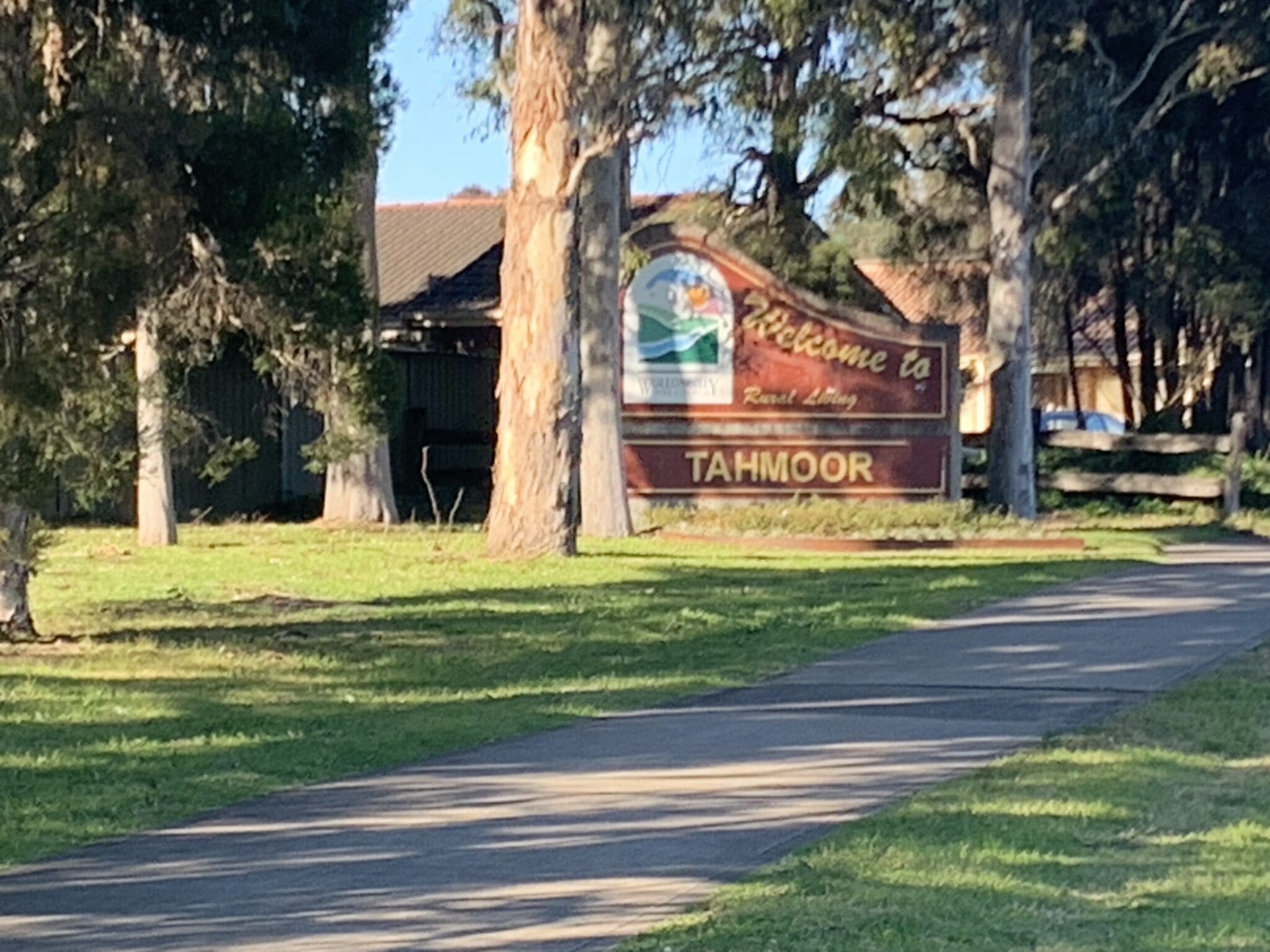 Welcome to Tahmoor sign with large trees Welcome to Tahmoor sign with Large Eucalypts big enough to contain termite nests